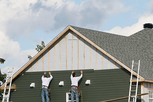 Professional Siding technician working in Ault, CO
